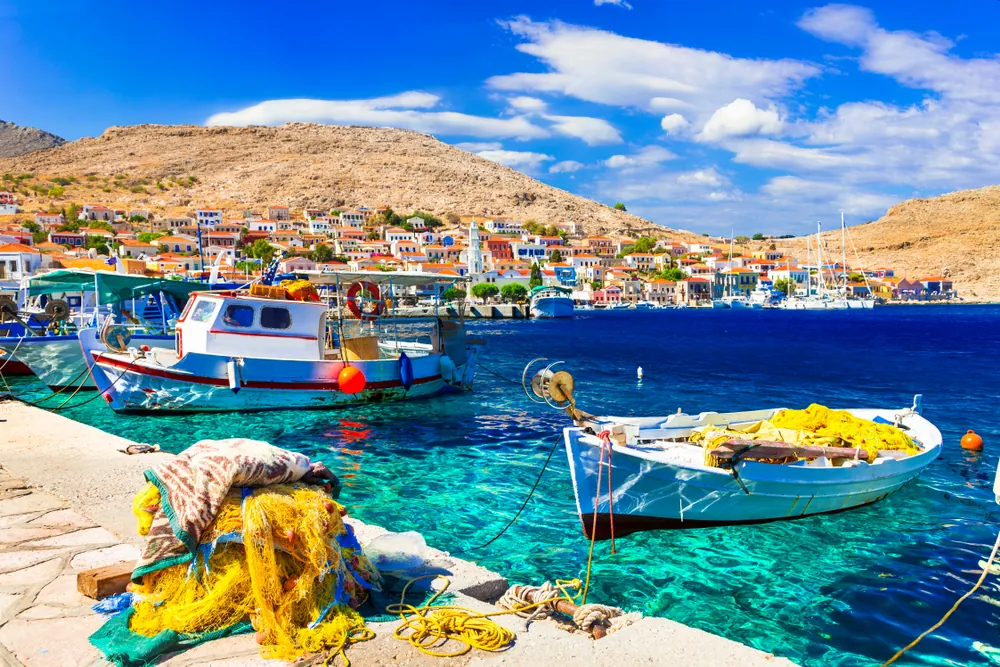 Fishing boats and colourful houses in the harbour of Chalki