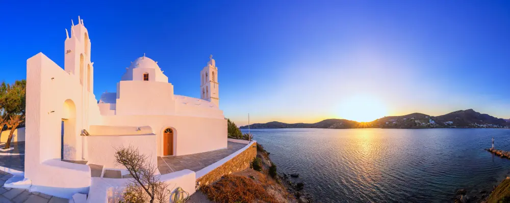 A white chapel above the bay of Ios at sunset