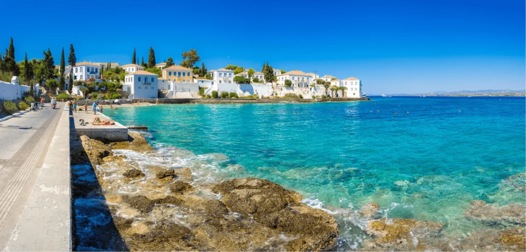 White mansions and clear turquoise water on the coast of Spetses
