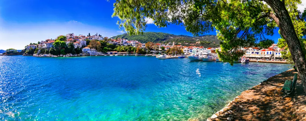 Turquoise water and the town of Skiathos on its hill