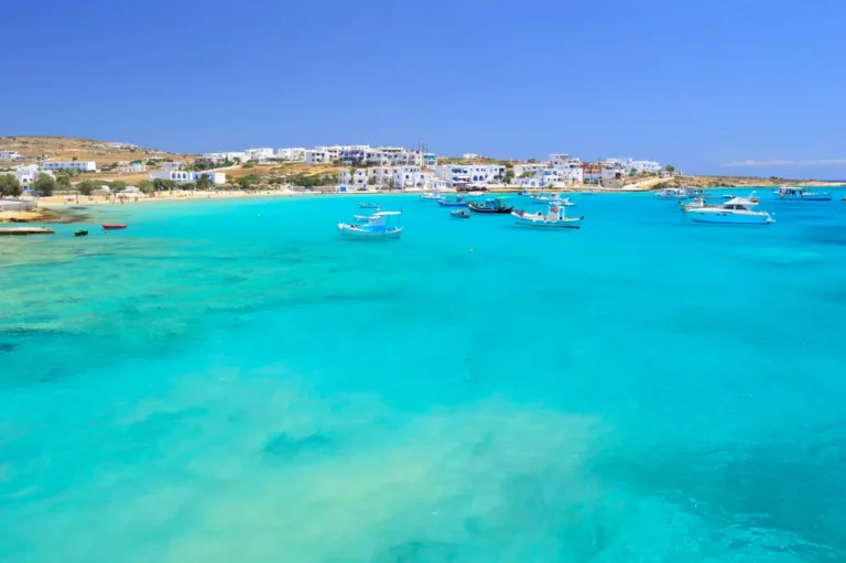 Fishing boats in the turquoise harbour bay below the white houses of Chora, Koufonisia